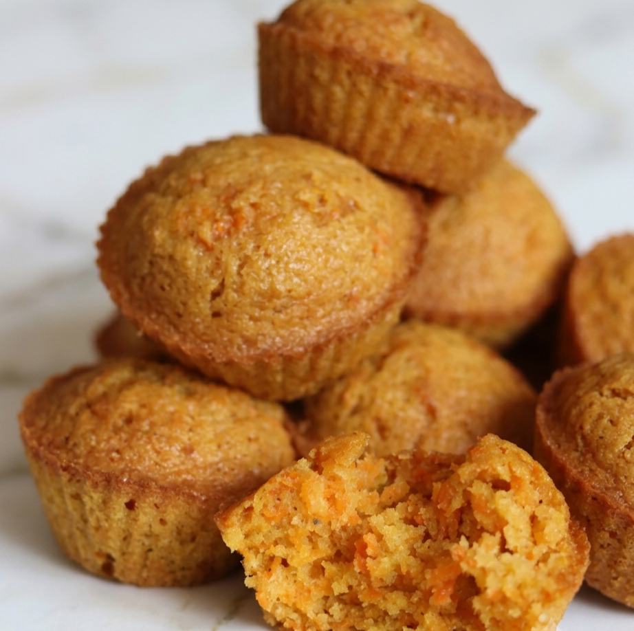 Fresh carrot muffin ingredients arranged on a kitchen countertop