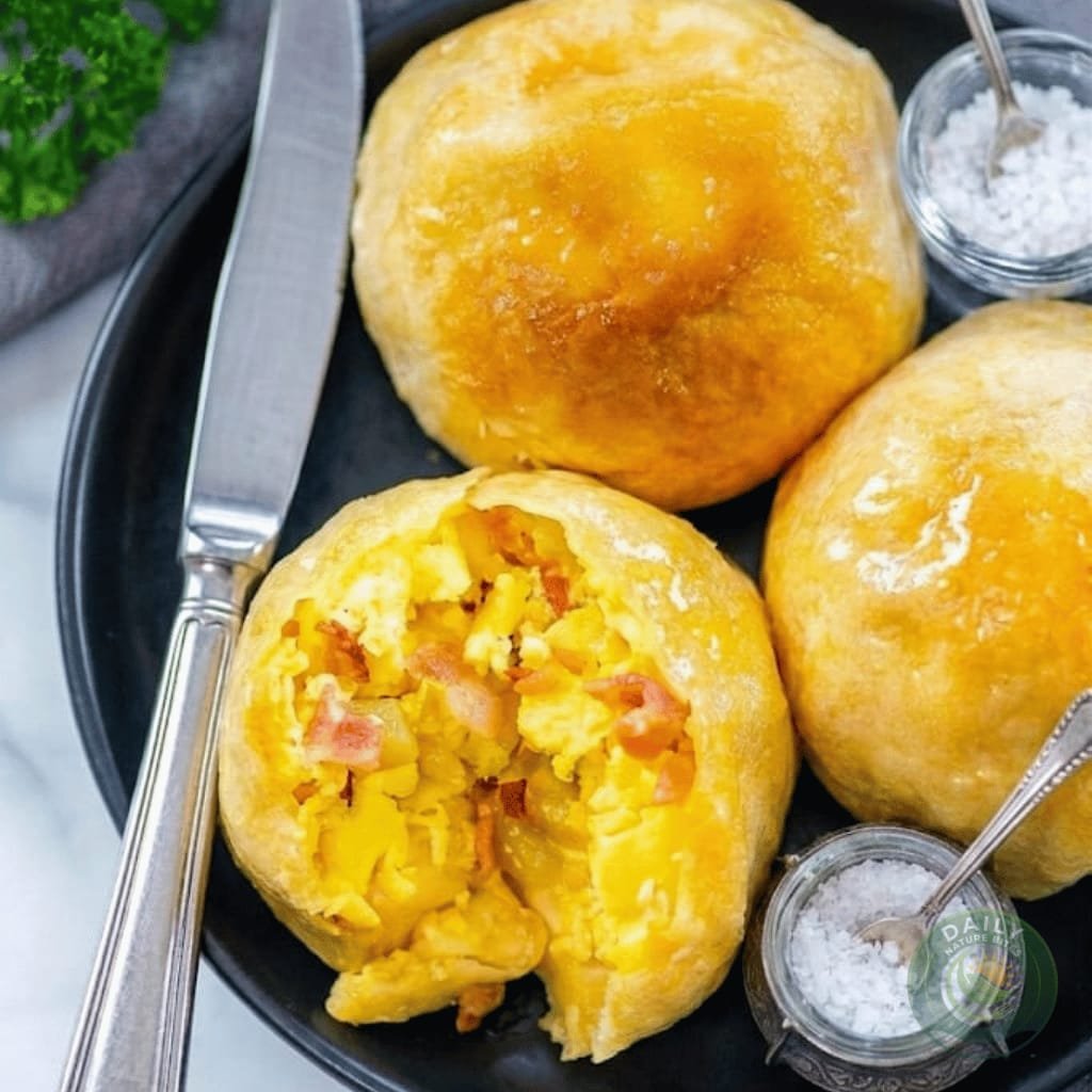 Golden air fryer breakfast bomb with maple syrup drizzle showing the savory egg and bacon filling