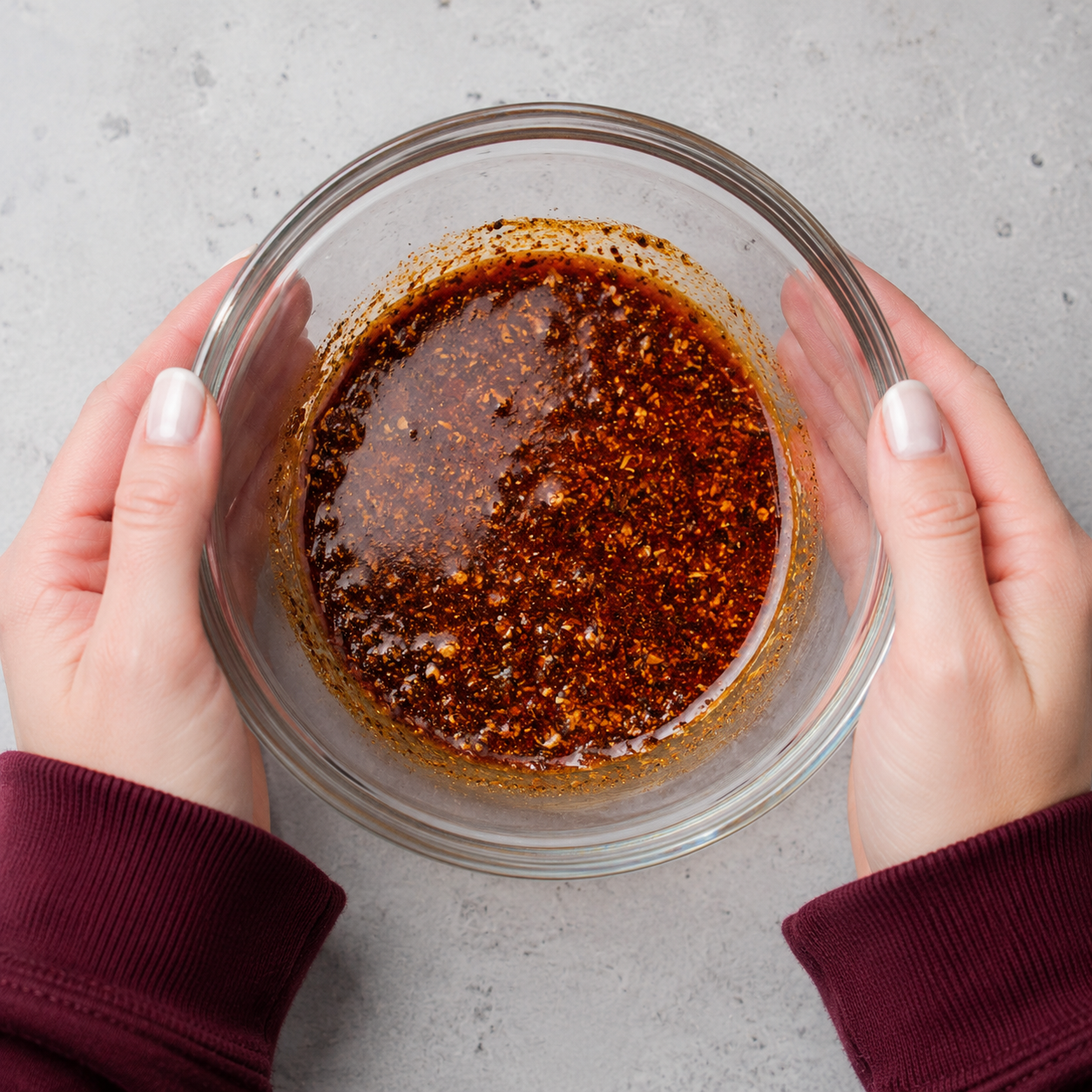 Small bowl of herb and spice paste with olive oil, paprika, oregano, garlic powder, salt, and pepper