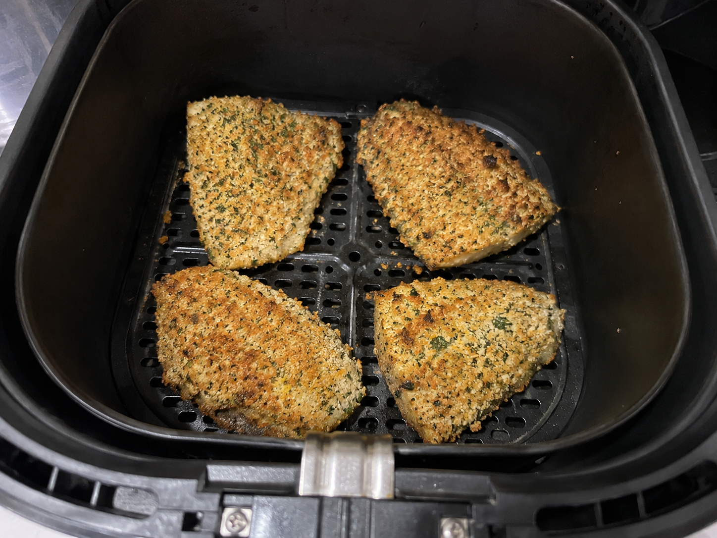 Wholemeal bread, tortilla chips, parsley, and fresh lemon zest being processed into coarse crumbs